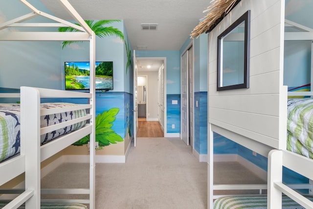 carpeted bedroom with a textured ceiling