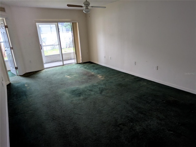 empty room featuring ceiling fan, dark carpet, visible vents, and baseboards