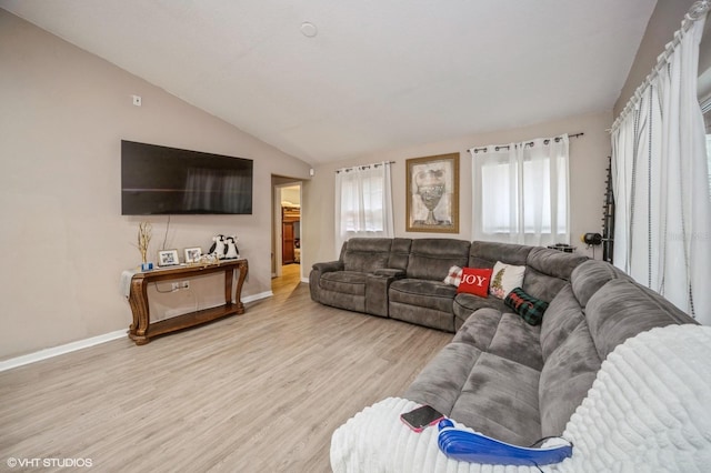 living room featuring light hardwood / wood-style floors and lofted ceiling