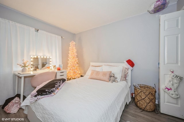 bedroom with hardwood / wood-style flooring