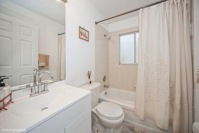 full bathroom featuring vanity, toilet, and shower / tub combo