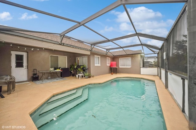 view of swimming pool with a lanai, a patio area, and outdoor lounge area