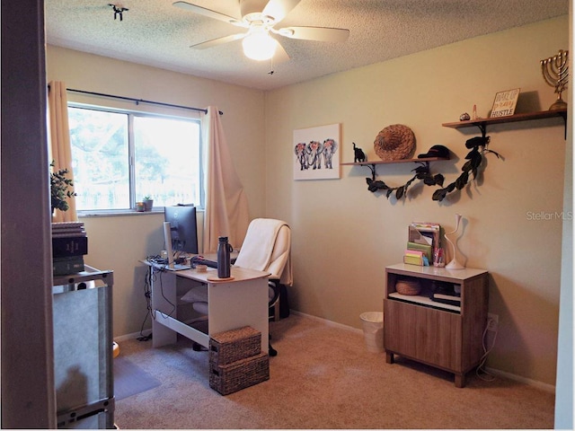 office with a textured ceiling, carpet floors, and ceiling fan