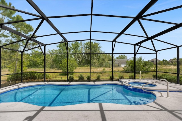 view of pool featuring an in ground hot tub, a lanai, and a patio