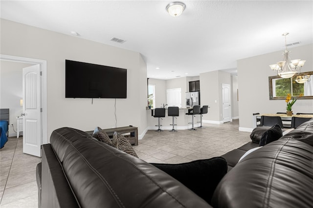 tiled living room featuring a notable chandelier