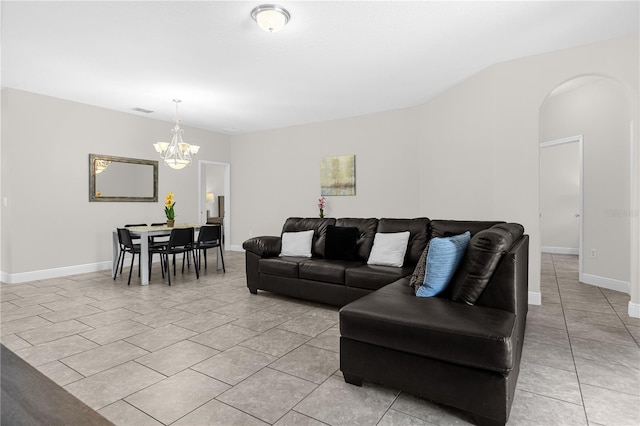 living room with light tile patterned flooring and a chandelier