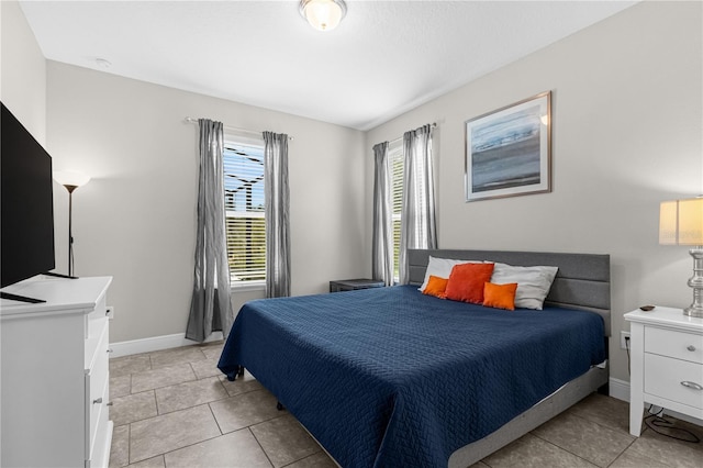 bedroom with light tile patterned floors