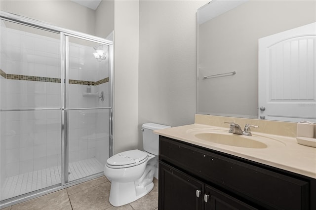 bathroom featuring vanity, a shower with shower door, tile patterned floors, and toilet