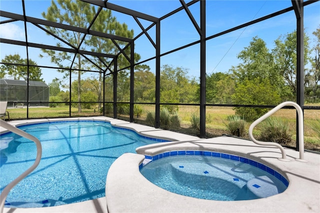 view of pool with a lanai and an in ground hot tub