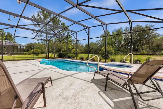 view of pool with a lanai, a patio area, and an in ground hot tub