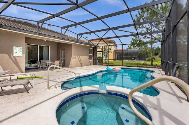 view of swimming pool with an in ground hot tub, a lanai, and a patio area