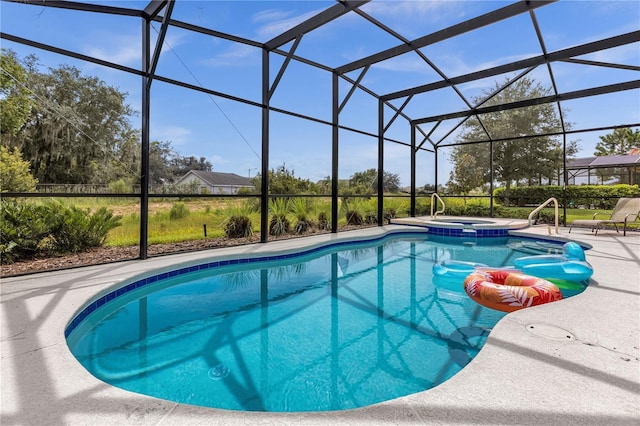 view of swimming pool with a patio area, an in ground hot tub, and glass enclosure