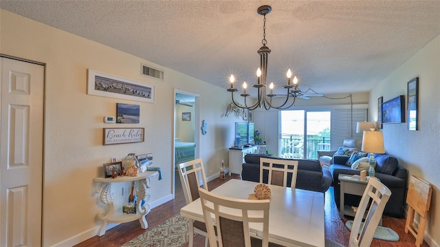 dining room featuring a chandelier, a textured ceiling, and hardwood / wood-style flooring