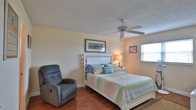 bedroom featuring a textured ceiling, ceiling fan, and dark hardwood / wood-style floors