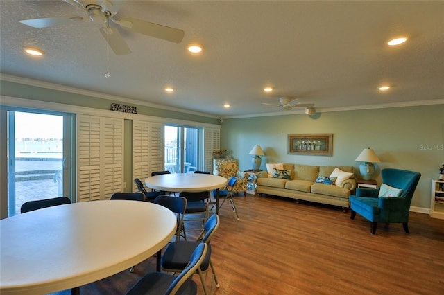 dining space featuring wood-type flooring, crown molding, and a wealth of natural light