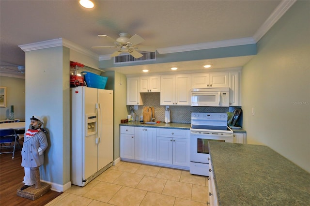 kitchen featuring white appliances, white cabinetry, crown molding, and sink