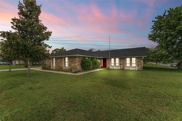 ranch-style house featuring a yard