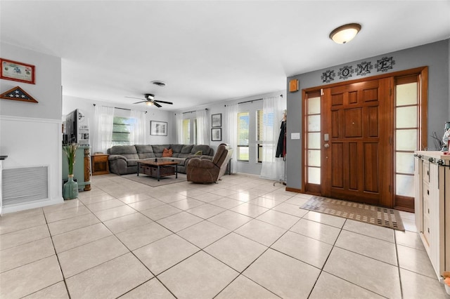 tiled entryway featuring plenty of natural light and ceiling fan