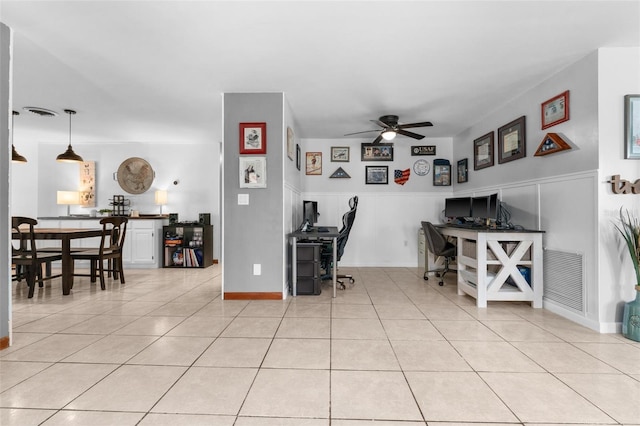 interior space with light tile patterned floors and ceiling fan