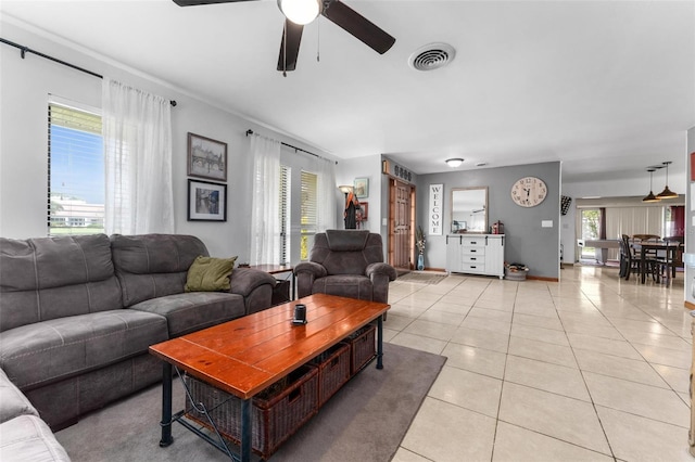 tiled living room featuring ceiling fan