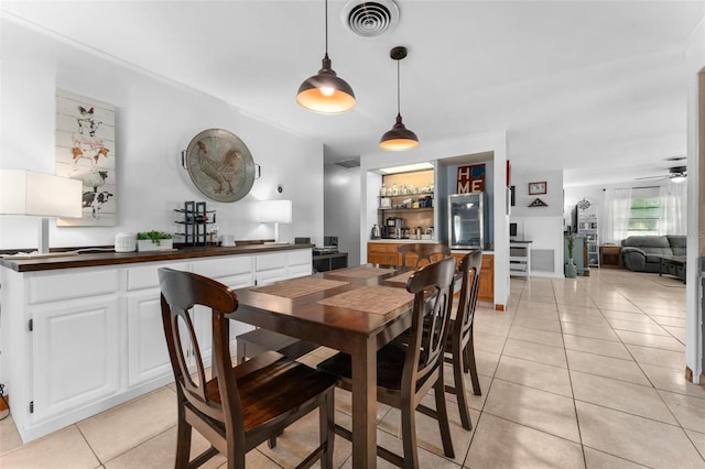 dining area featuring light tile patterned floors and ceiling fan