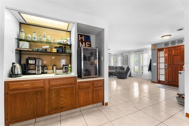 bar featuring light tile patterned floors and sink