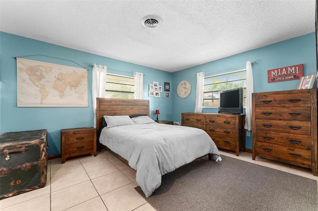 tiled bedroom with a textured ceiling