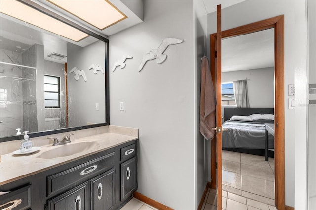 bathroom featuring tile patterned flooring, vanity, and a shower