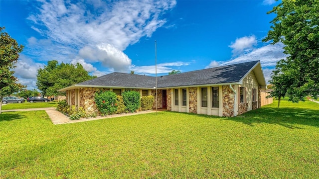 rear view of property featuring a yard