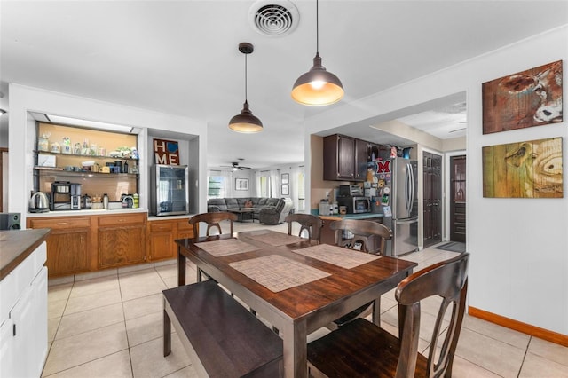 dining area with light tile patterned floors and ceiling fan