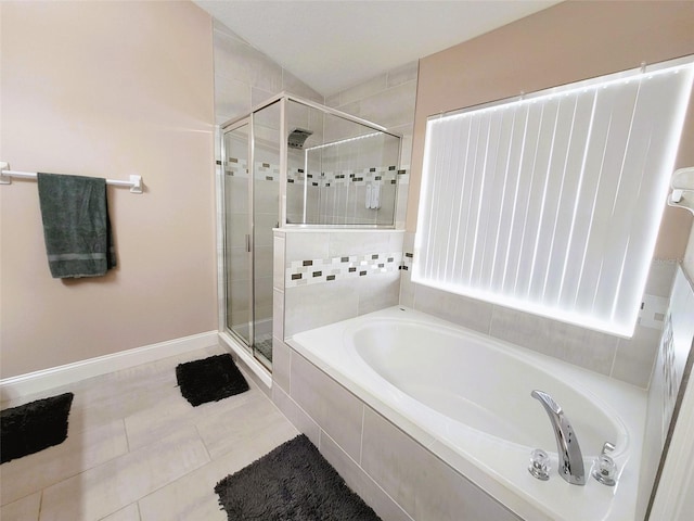 bathroom with plus walk in shower and tile patterned flooring