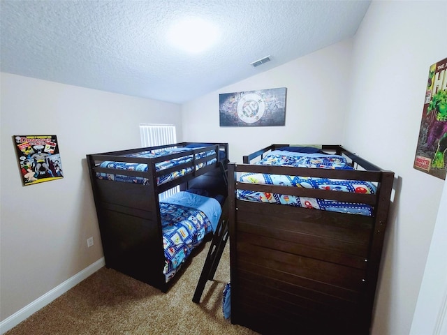 bedroom featuring a textured ceiling, vaulted ceiling, and carpet floors