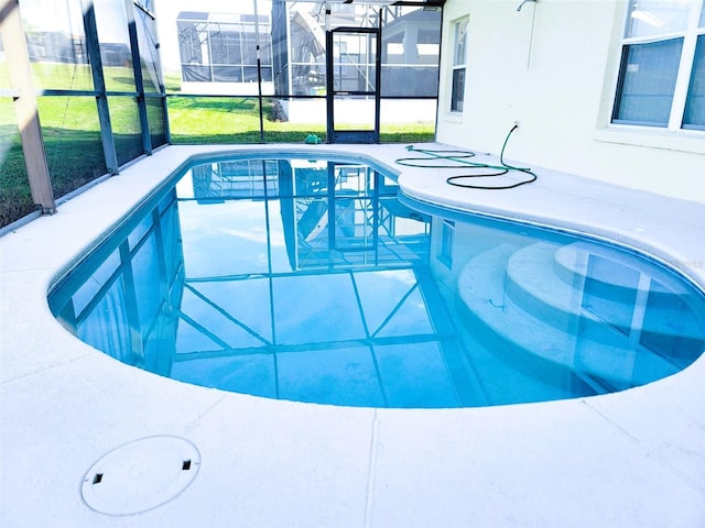 view of pool featuring a lanai and a yard