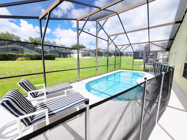 view of pool with a lanai and a yard