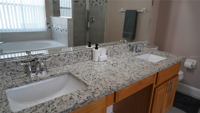 full bathroom with toilet, vanity, and separate shower and tub