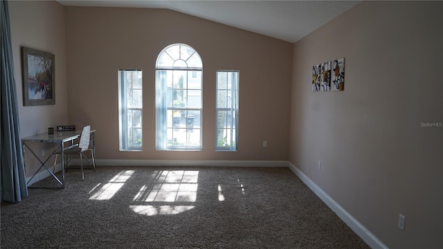 interior space with carpet floors and vaulted ceiling