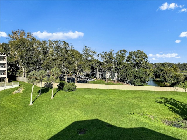 view of home's community featuring a water view and a yard