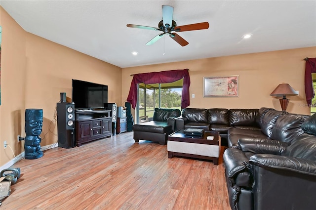 living room with wood-type flooring and ceiling fan