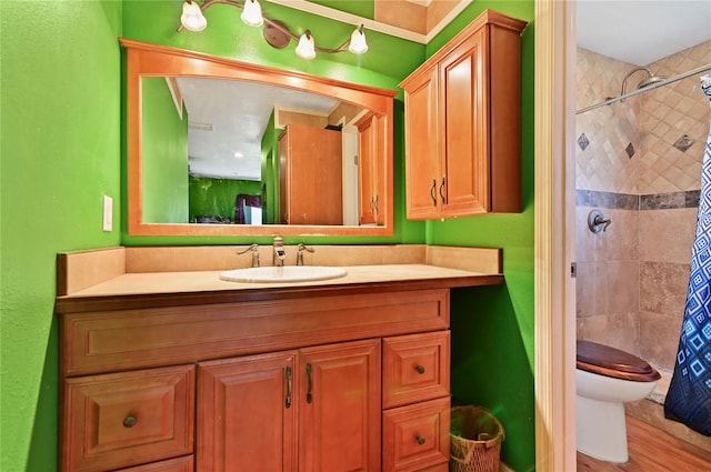 bathroom with hardwood / wood-style flooring, vanity, and toilet