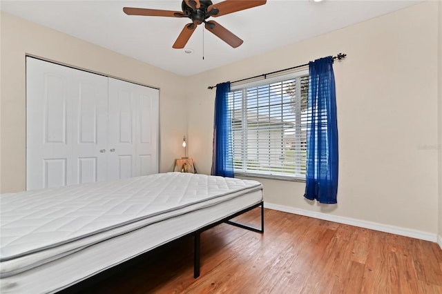 bedroom featuring hardwood / wood-style floors, a closet, and ceiling fan