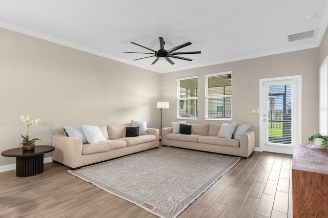 living room featuring hardwood / wood-style floors, ceiling fan, and ornamental molding