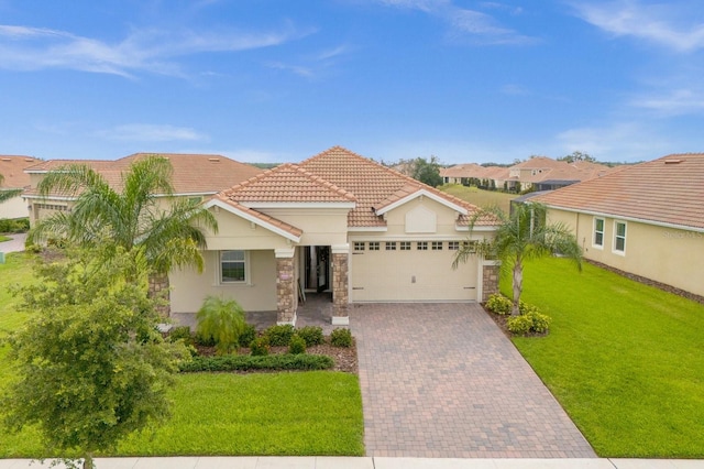 mediterranean / spanish house featuring a garage and a front lawn