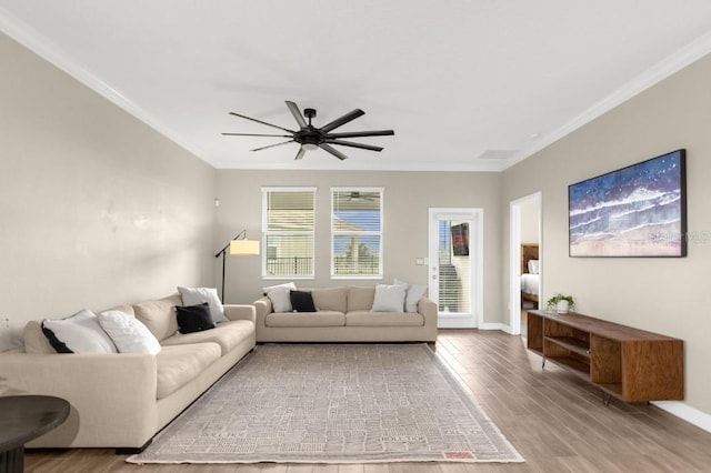 living room featuring ceiling fan, wood-type flooring, and crown molding