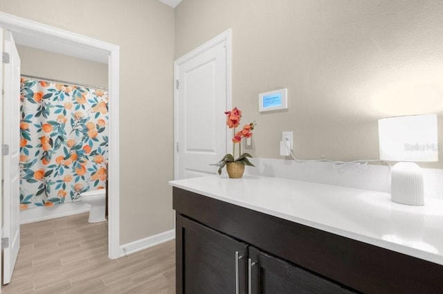 bathroom featuring hardwood / wood-style flooring, vanity, and toilet