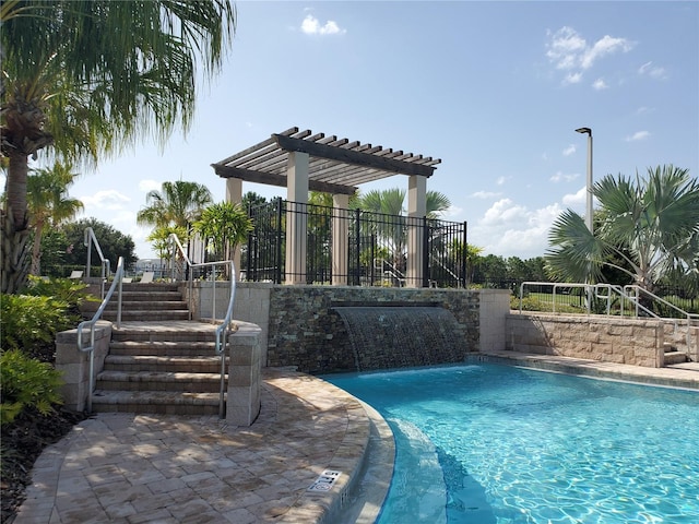 view of pool with pool water feature and a pergola