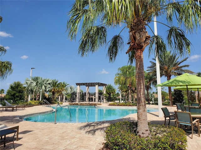 view of swimming pool featuring a pergola and a patio area