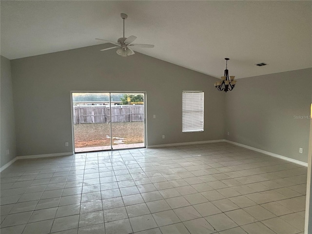 tiled spare room featuring ceiling fan with notable chandelier and vaulted ceiling