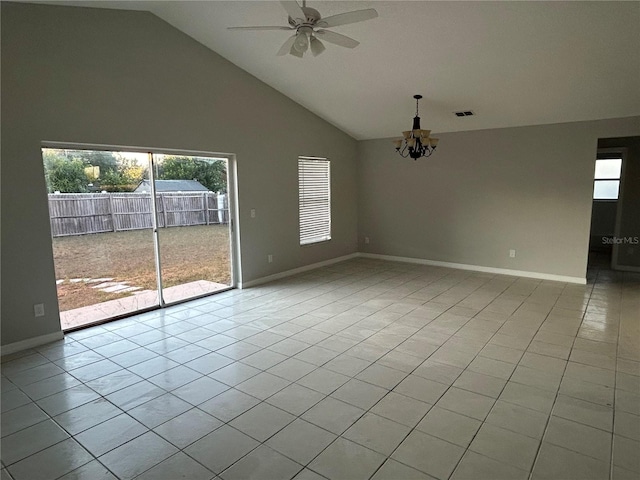 spare room with light tile patterned floors, ceiling fan with notable chandelier, and high vaulted ceiling