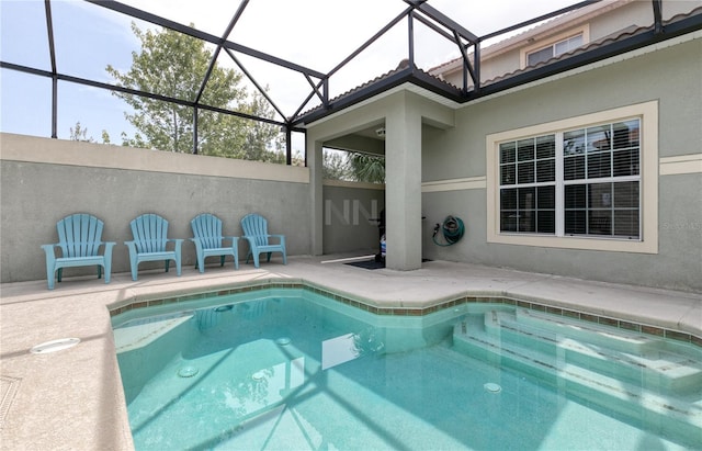 view of swimming pool featuring glass enclosure and a patio area