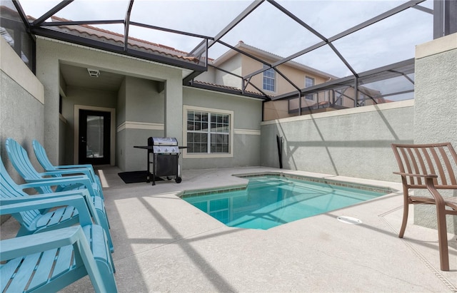 outdoor pool with a patio, a grill, and glass enclosure